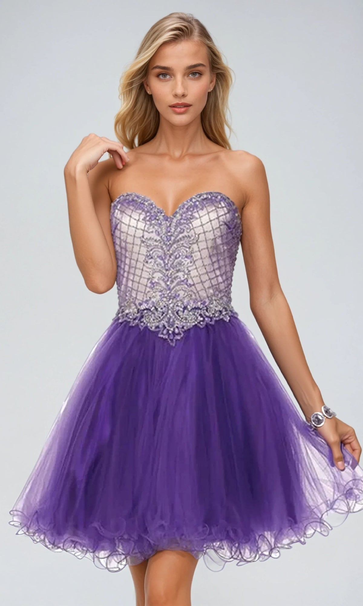 A woman models the Short Babydoll Hoco Dress: Juliet 778—strapless with a beaded silver bodice, sweetheart neckline, short purple tulle skirt, and lace-up back—standing against a plain light background.